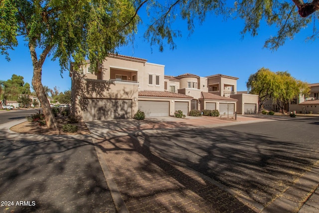 mediterranean / spanish home featuring a garage