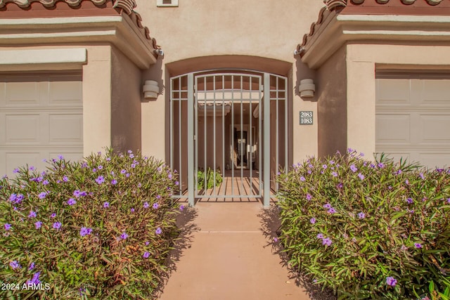 view of exterior entry with a garage