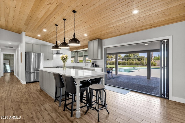 5112 E Cholla St, Scottsdale, AZ 85254 - kitchen featuring freestanding refrigerator, wooden ceiling, gray cabinets, light countertops, and a center island
