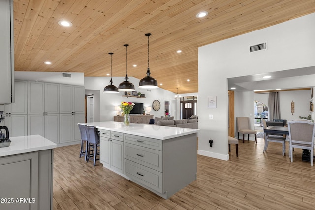 5112 E Cholla St, Scottsdale, AZ 85254 - kitchen featuring gray cabinetry, wood ceiling, a center island, light countertops, and a breakfast bar