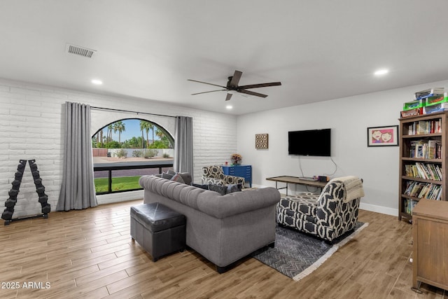 5112 E Cholla St, Scottsdale, AZ 85254 - living room with a ceiling fan, light wood finished floors, recessed lighting, and brick wall