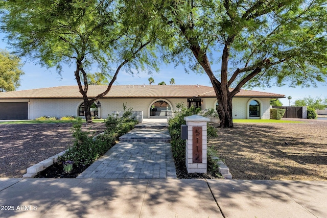 5112 E Cholla St, Scottsdale, AZ 85254 - view of front of house featuring a tile roof, an attached garage, and brick siding