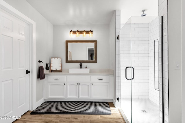 5112 E Cholla St, Scottsdale, AZ 85254 - bathroom featuring wood finished floors, a shower stall, vanity, and baseboards