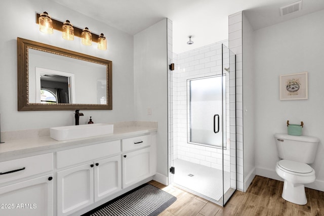 5112 E Cholla St, Scottsdale, AZ 85254 - full bathroom featuring wood finished floors, a shower stall, toilet, vanity, and baseboards
