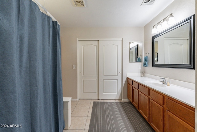 bathroom with tile patterned floors, vanity, and a shower with curtain