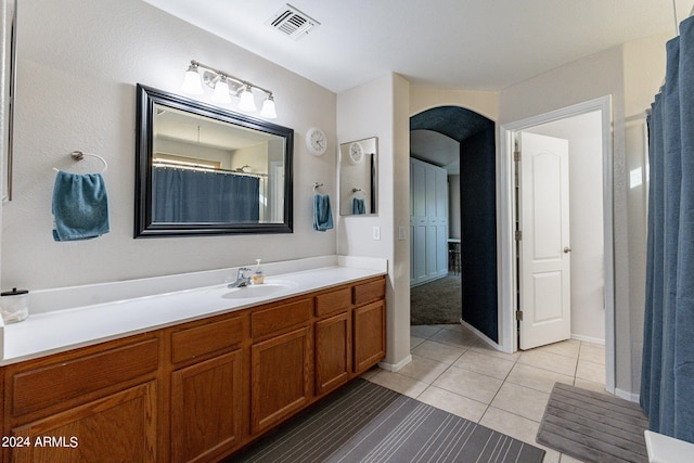 bathroom featuring tile patterned flooring and vanity