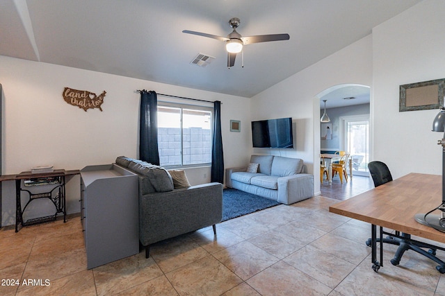 tiled living room with vaulted ceiling and ceiling fan