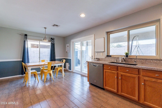 kitchen with hardwood / wood-style floors, dishwasher, pendant lighting, and sink