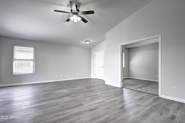 spare room featuring hardwood / wood-style flooring, ceiling fan, and lofted ceiling