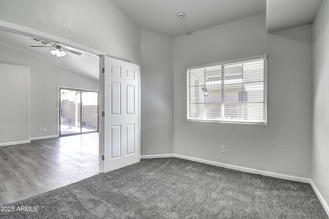 carpeted spare room featuring ceiling fan and lofted ceiling