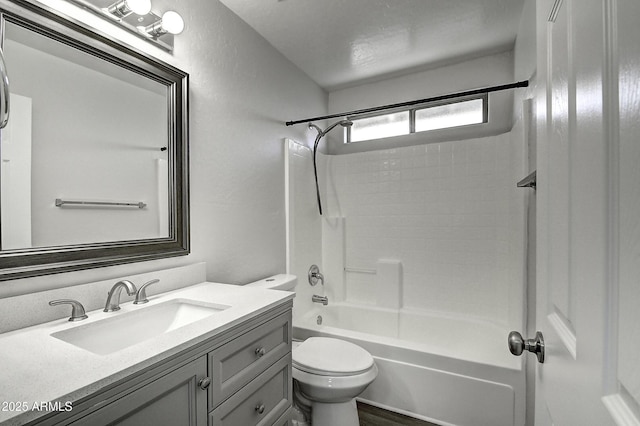 full bathroom featuring vanity, tub / shower combination, and toilet