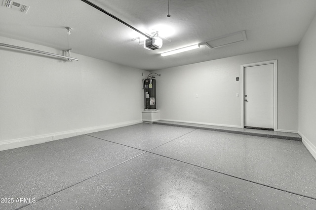 garage featuring a garage door opener and electric water heater