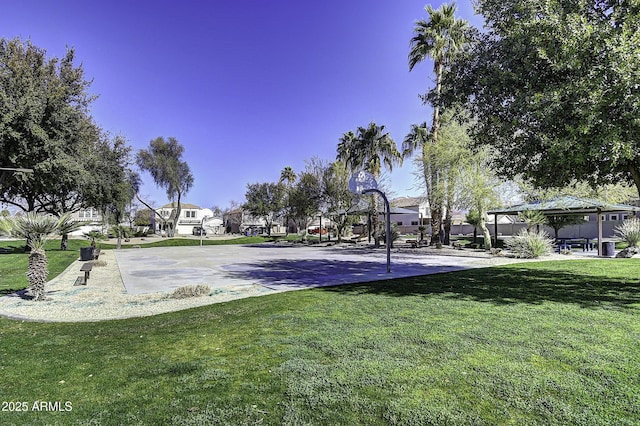 view of basketball court with a lawn