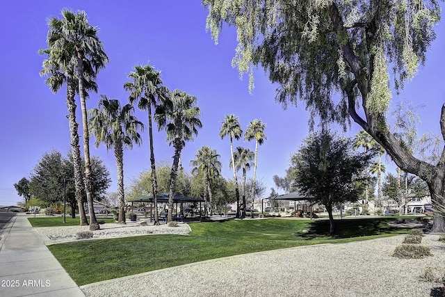 surrounding community with a gazebo and a yard