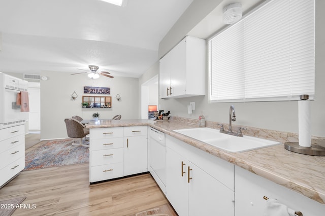 10873 W Clair Dr, Sun City, AZ 85351 - kitchen with a peninsula, light countertops, white dishwasher, and light wood-type flooring