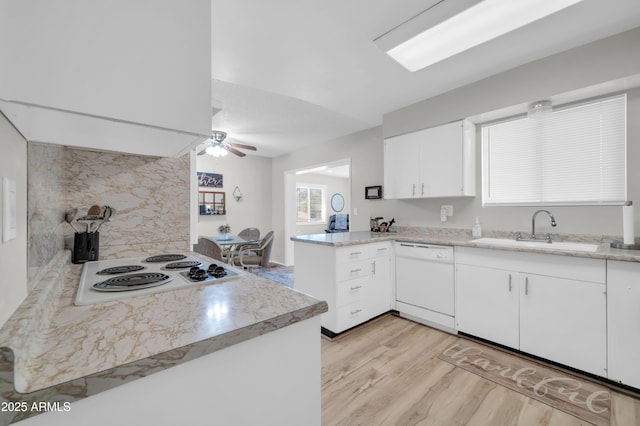 10873 W Clair Dr, Sun City, AZ 85351 - kitchen with white appliances, a peninsula, ceiling fan, light countertops, and light wood-style floors