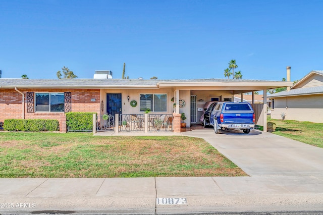 10873 W Clair Dr, Sun City, AZ 85351 - single story home with brick siding, a front lawn, driveway, and a carport
