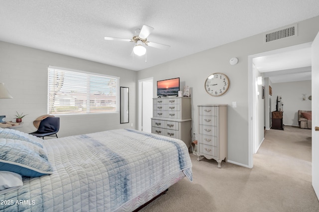10873 W Clair Dr, Sun City, AZ 85351 - bedroom featuring light carpet, ceiling fan, and a textured ceiling