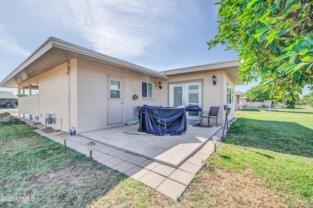 10873 W Clair Dr, Sun City, AZ 85351 - back of house with a patio area, a yard, and french doors