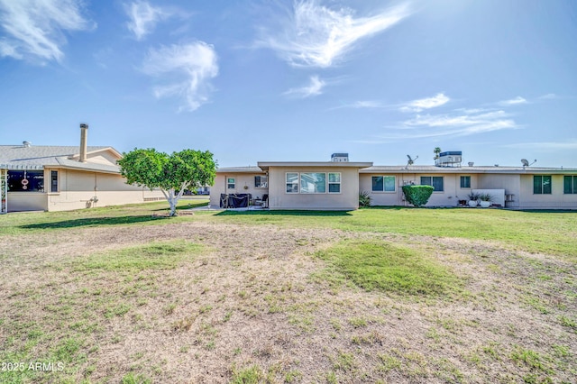 10873 W Clair Dr, Sun City, AZ 85351 - back of house featuring a lawn