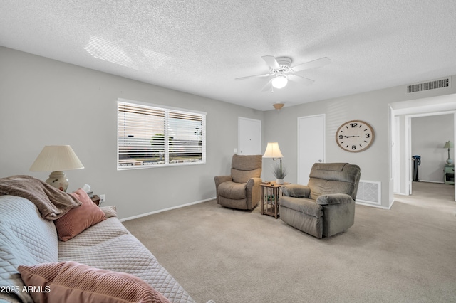10873 W Clair Dr, Sun City, AZ 85351 - carpeted living room with ceiling fan and a textured ceiling