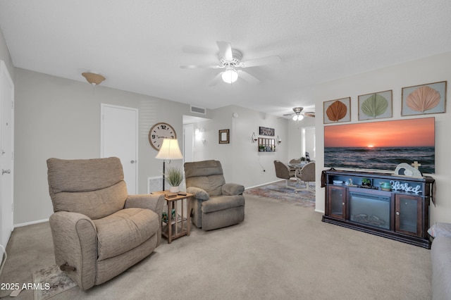 10873 W Clair Dr, Sun City, AZ 85351 - living room featuring a ceiling fan and carpet