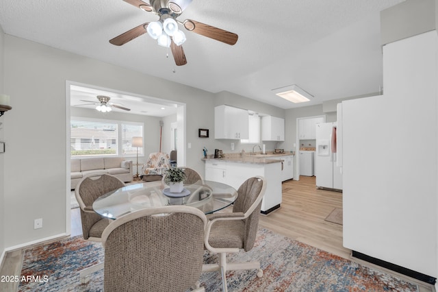 10873 W Clair Dr, Sun City, AZ 85351 - dining space featuring light wood finished floors, a ceiling fan, and a textured ceiling