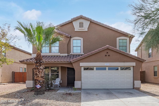 view of front of home featuring concrete driveway, fence, a tiled roof, and stucco siding