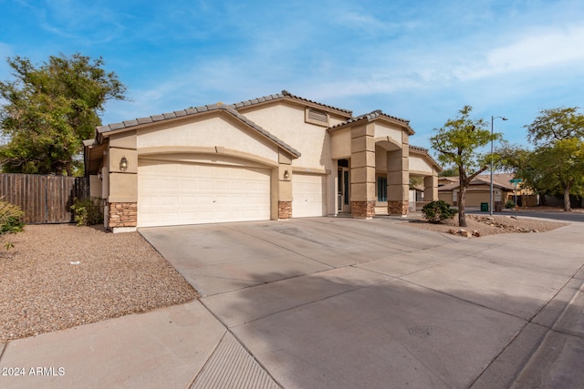 mediterranean / spanish-style home with a garage