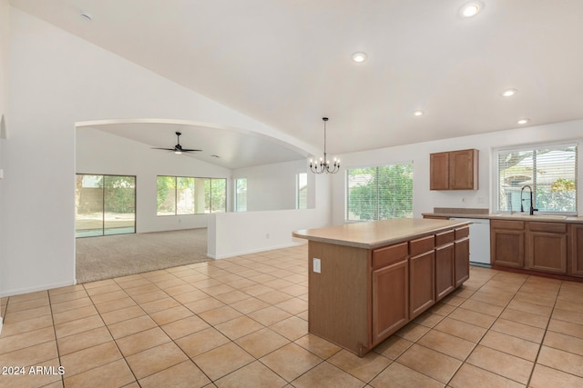 kitchen with a center island, sink, hanging light fixtures, white dishwasher, and ceiling fan with notable chandelier