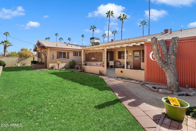 rear view of house featuring a lawn and a patio area