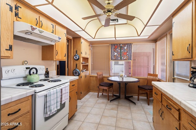 kitchen featuring electric stove, ceiling fan, tile countertops, and light tile patterned floors