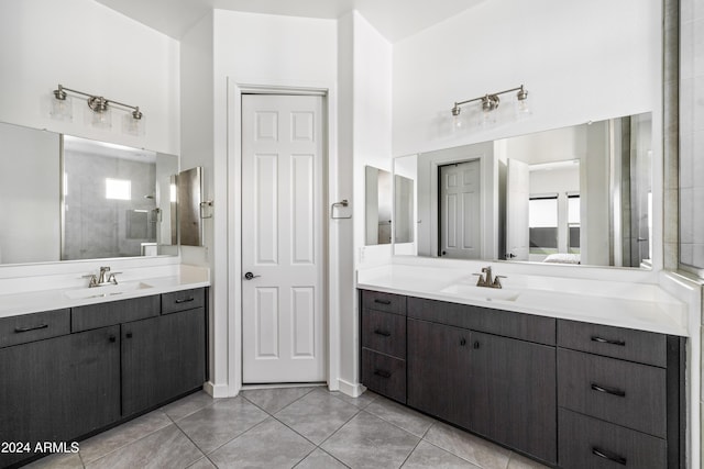 bathroom with tile patterned floors, vanity, and tiled shower