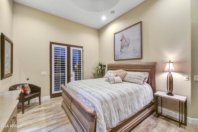 bedroom with light wood-type flooring and access to outside