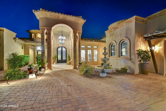 exterior entry at night featuring french doors