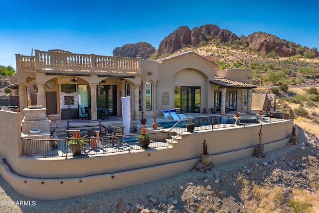 back of house with a mountain view and a patio