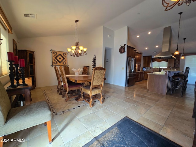 dining area featuring light tile patterned floors, high vaulted ceiling, and an inviting chandelier