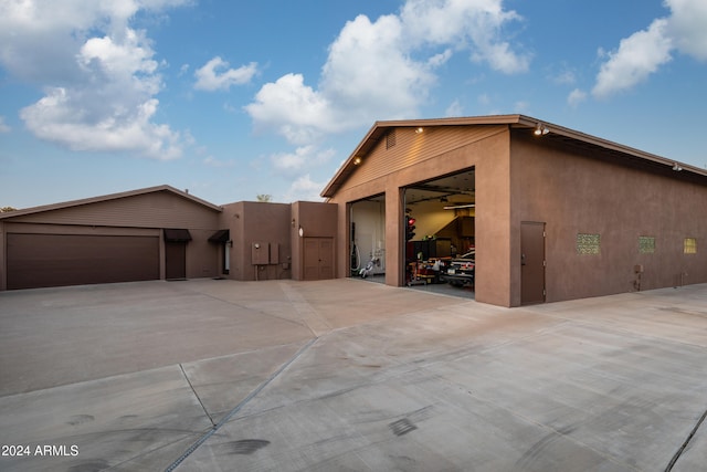 view of side of property with an outdoor structure and a garage