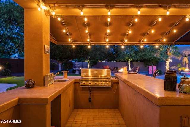 view of patio / terrace featuring area for grilling, a grill, and sink