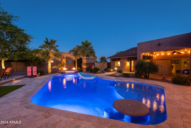 view of swimming pool featuring a hot tub and a patio area