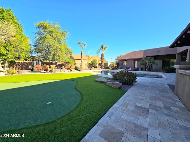 view of property's community featuring a patio area and a swimming pool