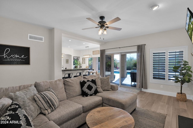 living room with ceiling fan and hardwood / wood-style flooring