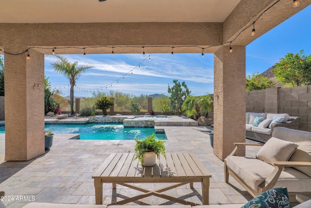 view of swimming pool featuring an outdoor living space, an in ground hot tub, and a patio