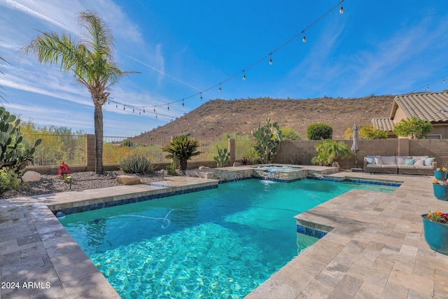 view of swimming pool with a mountain view, an in ground hot tub, an outdoor living space, and a patio