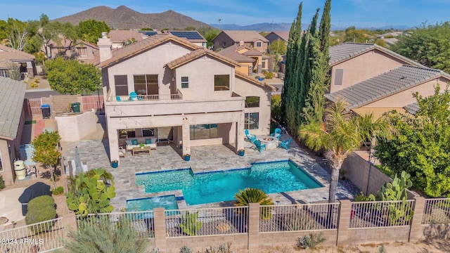 exterior space with an outdoor living space, a mountain view, a fenced in pool, a balcony, and a patio