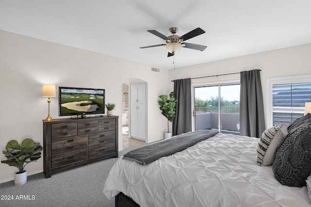 carpeted bedroom with access to outside, ceiling fan, and ensuite bathroom