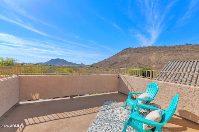 view of patio featuring a mountain view and a balcony