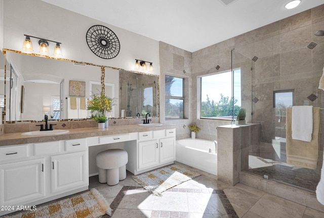 bathroom with separate shower and tub and vanity