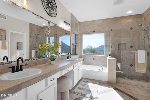 bathroom featuring a mountain view, vanity, and separate shower and tub