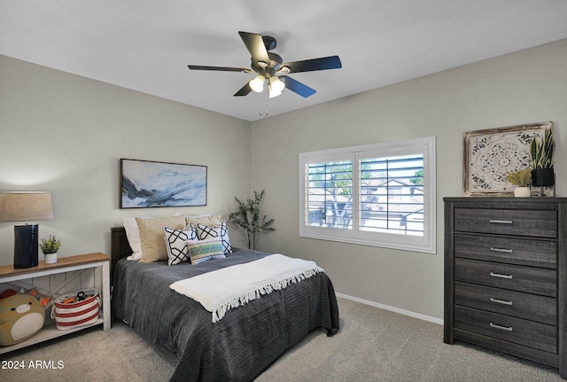 bedroom with ceiling fan and light carpet